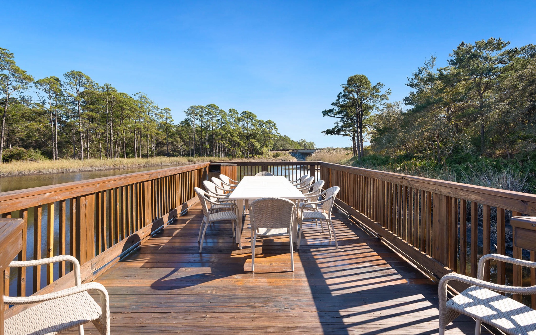 Step onto your private waterfront deck where morning coffee tastes better surrounded by marshland views and gentle water sounds.