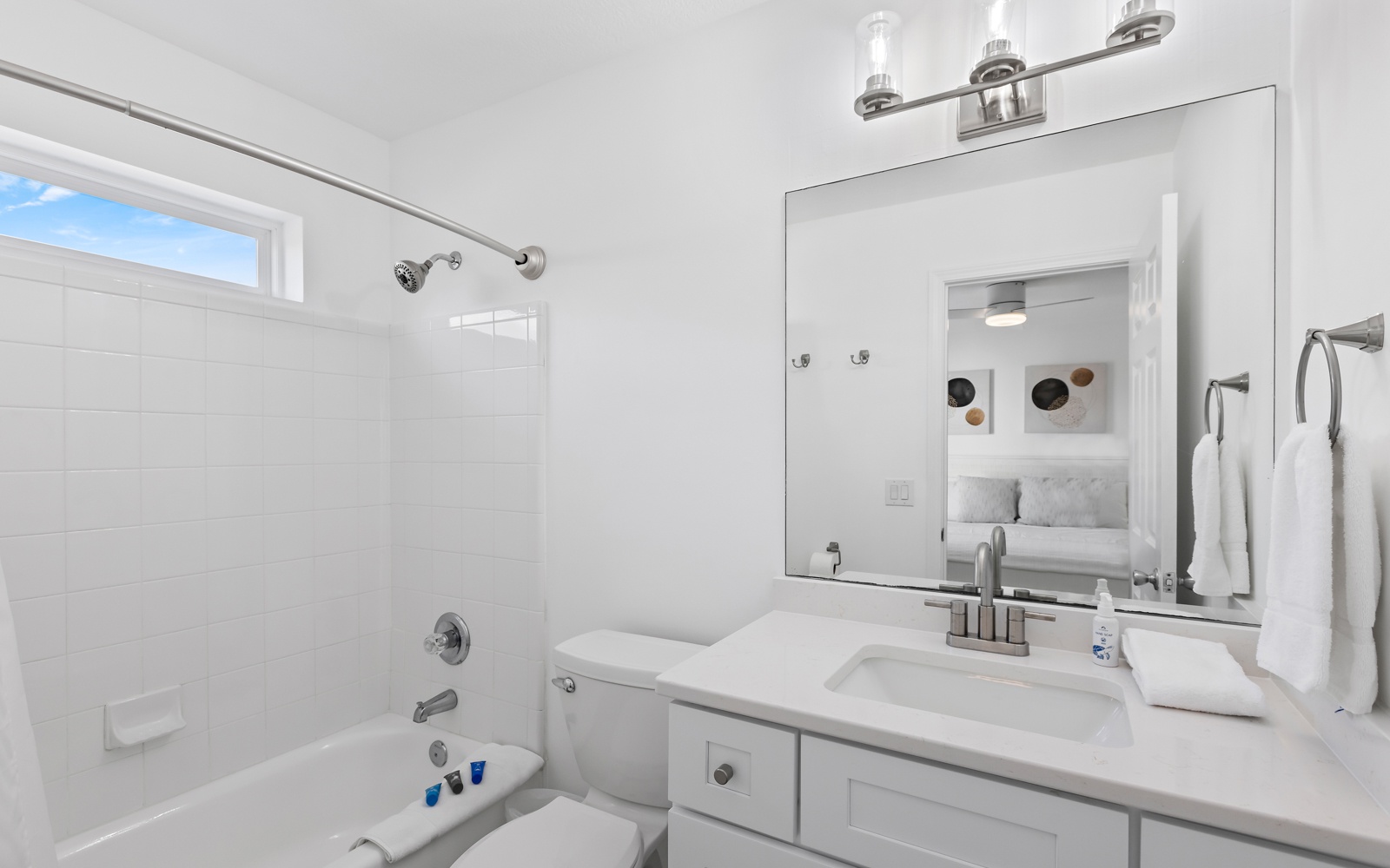 Refresh in this bright, modern bathroom with a deep soaking tub and natural light streaming through the window.