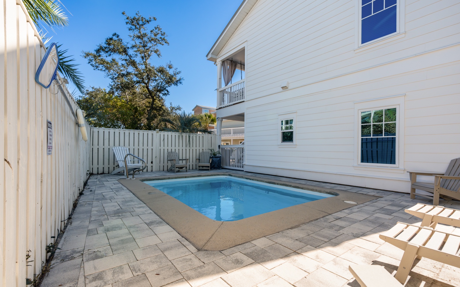 Your private pool sanctuary awaits, surrounded by sun-warmed stones and tropical palms for perfect Florida relaxation.