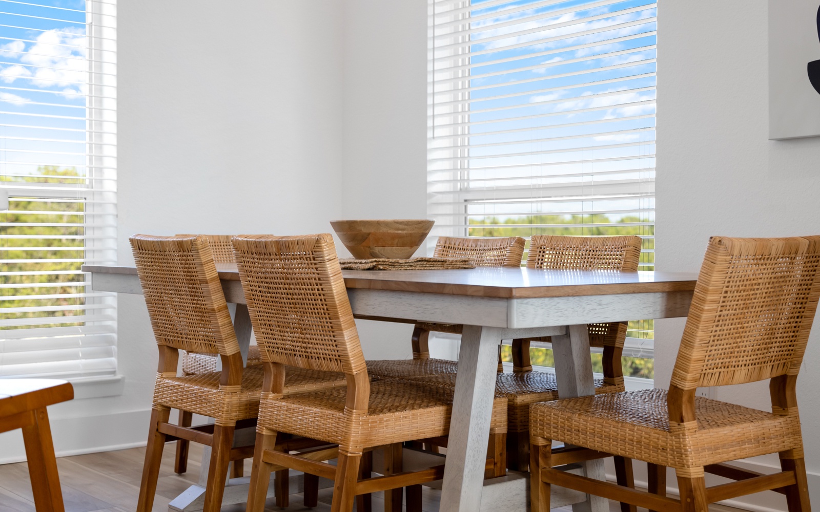 Savor meals together at your beautifully appointed dining table, where natural light streams through plantation shutters creating the perfect atmosphere for memorable conversations.