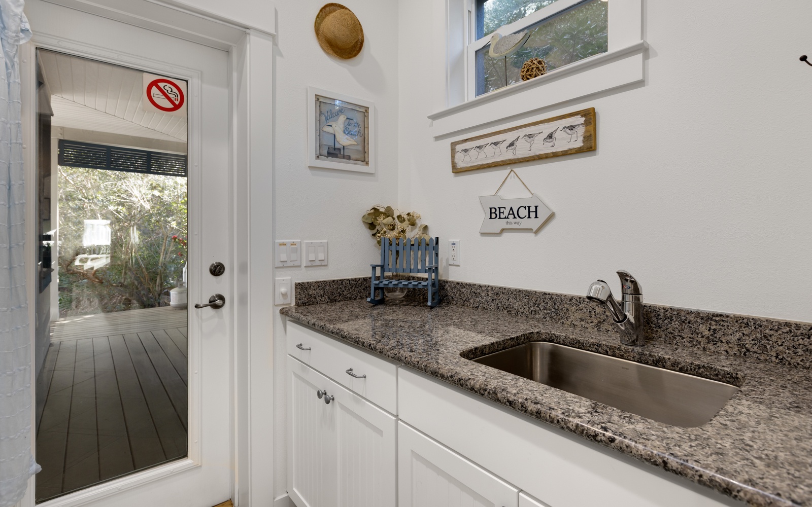 Your charming kitchenette features granite counters and coastal touches, perfect for preparing snacks between beach adventures.