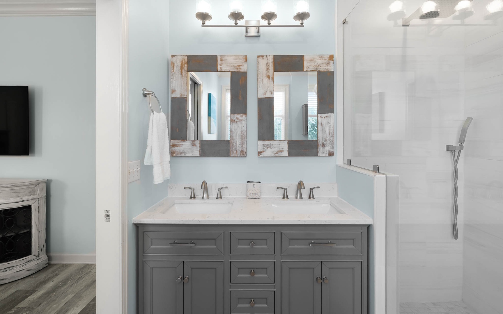 Step into your beautifully appointed bathroom featuring dual vanities, stylish mirrors, and a spacious shower for your refreshing getaway.