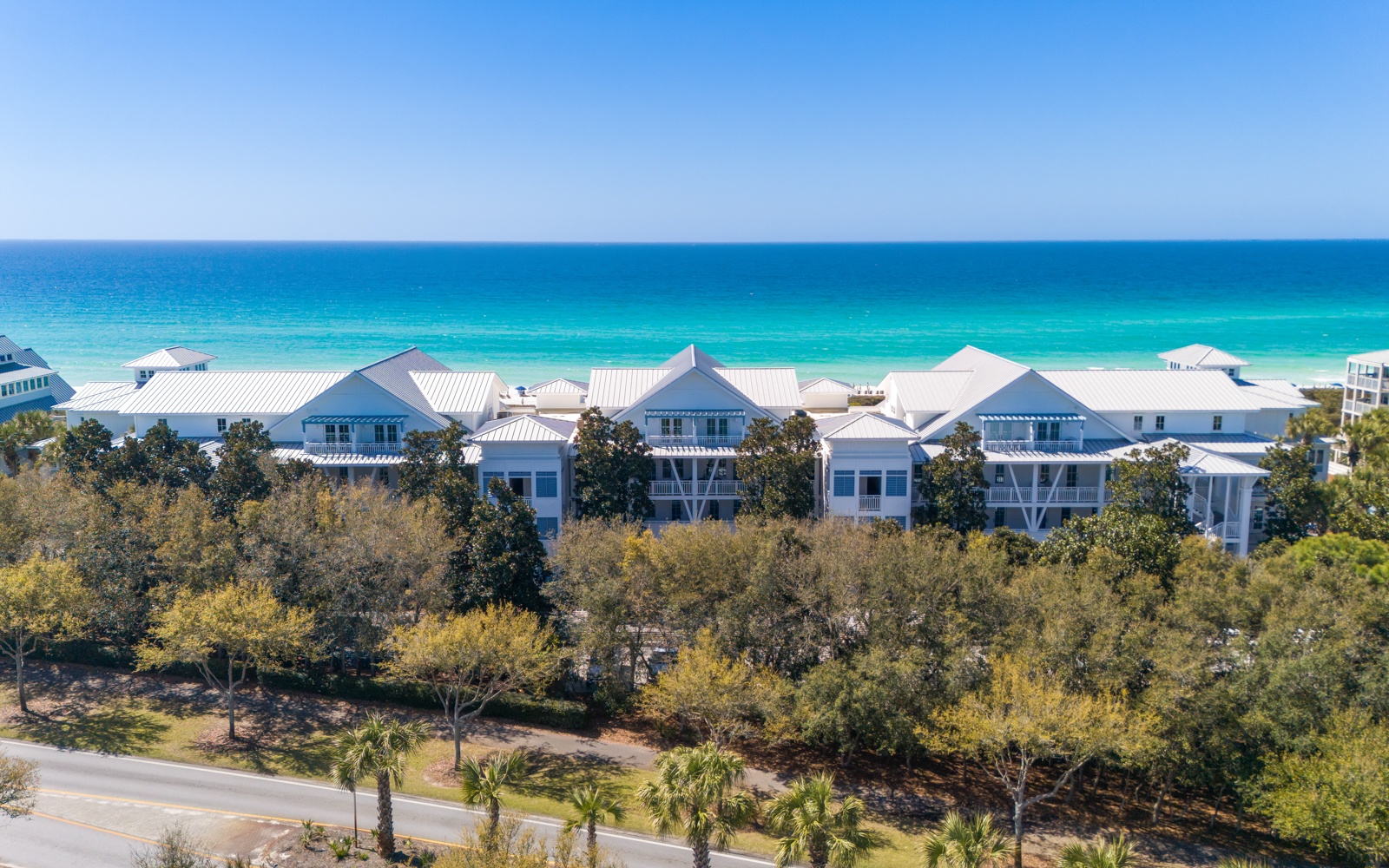 Stunning beachfront property featuring modern coastal architecture just steps from pristine turquoise waters and sugar-white sand beaches.