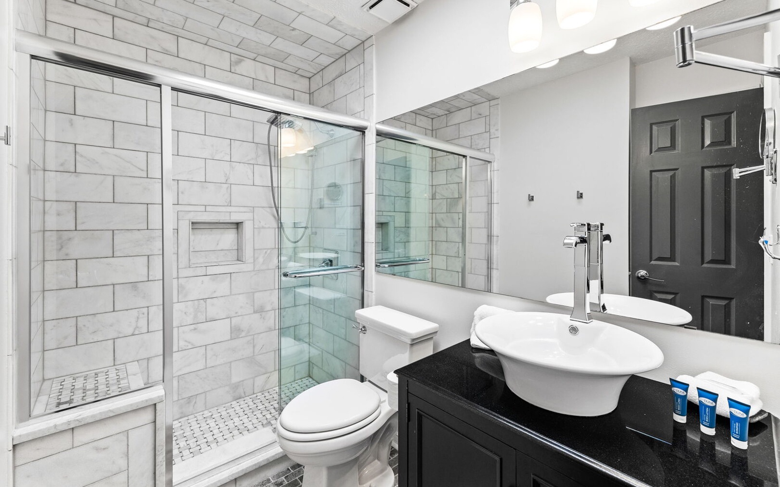 Luxurious marble-tiled bathroom with walk-in shower and elegant vanity awaits your daily refresh.
