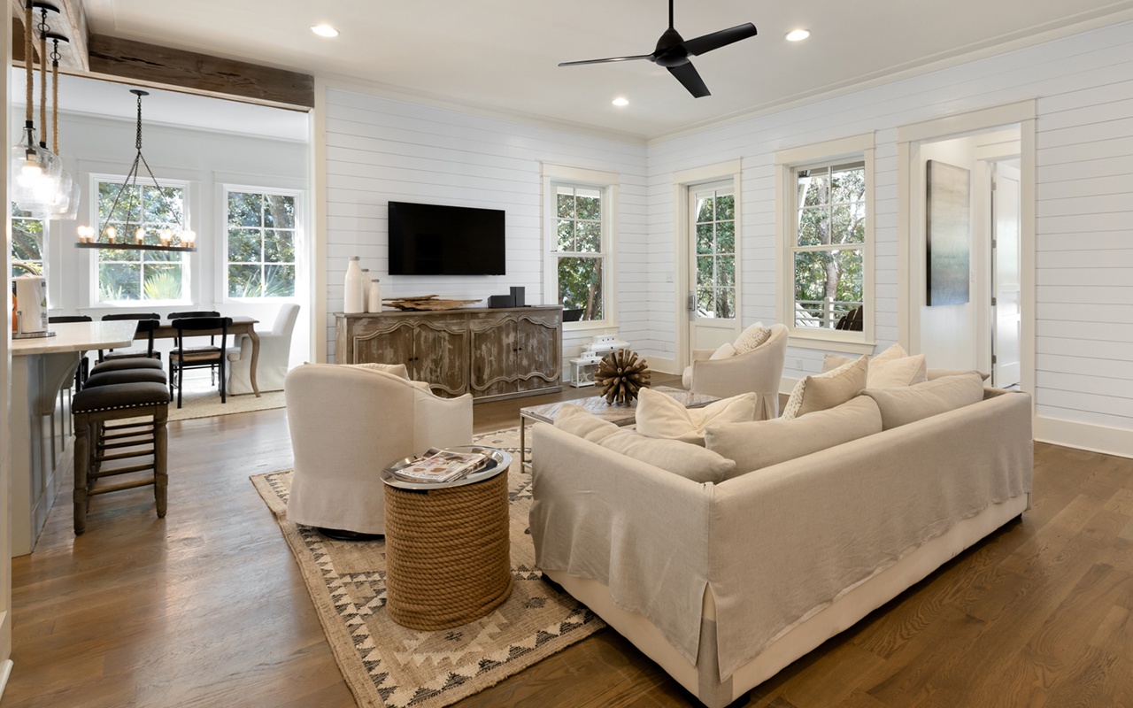 Relax in your elegant living space with shiplap walls, plush seating, and modern amenities for the perfect getaway.