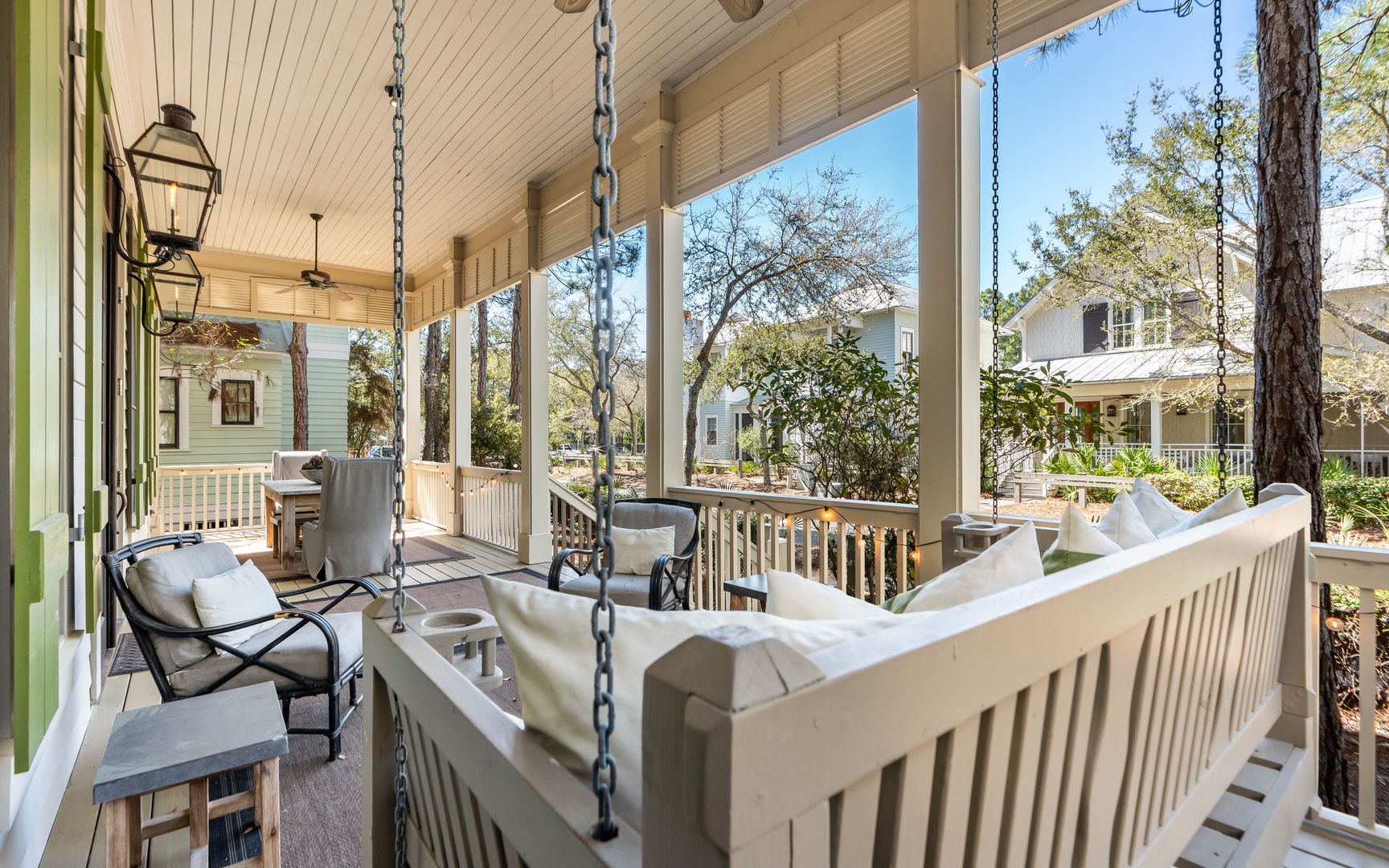 Unwind on your charming wraparound porch with a cozy swing and comfortable seating overlooking the peaceful neighborhood.