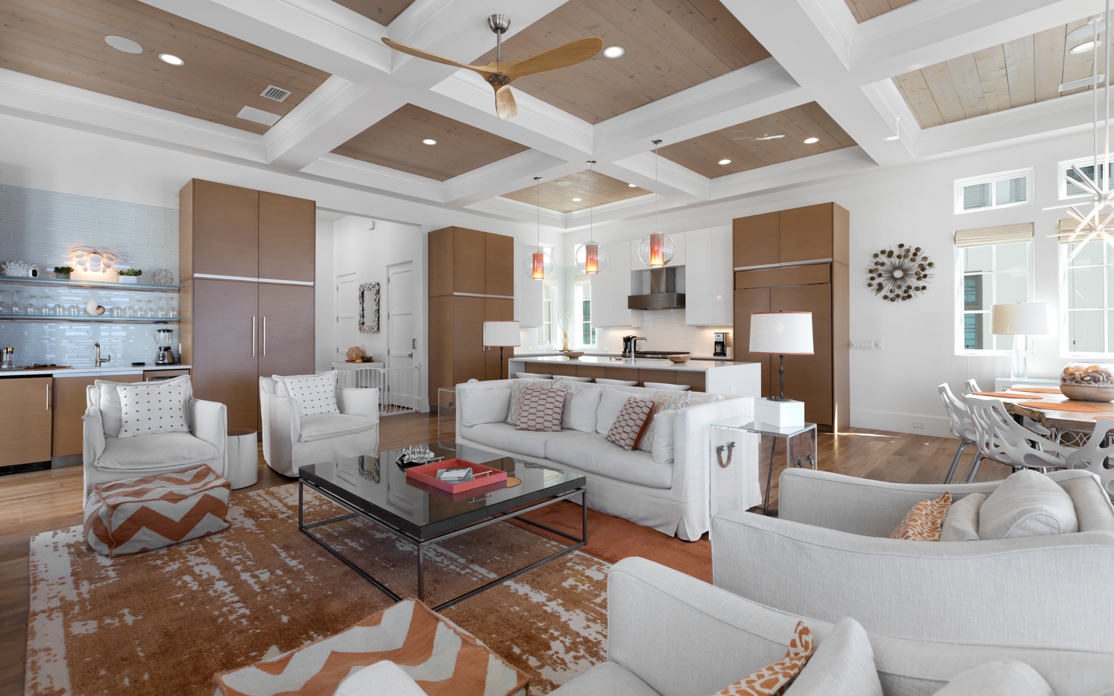 Relax in your spacious open-concept living space with soaring coffered ceilings and modern furnishings.