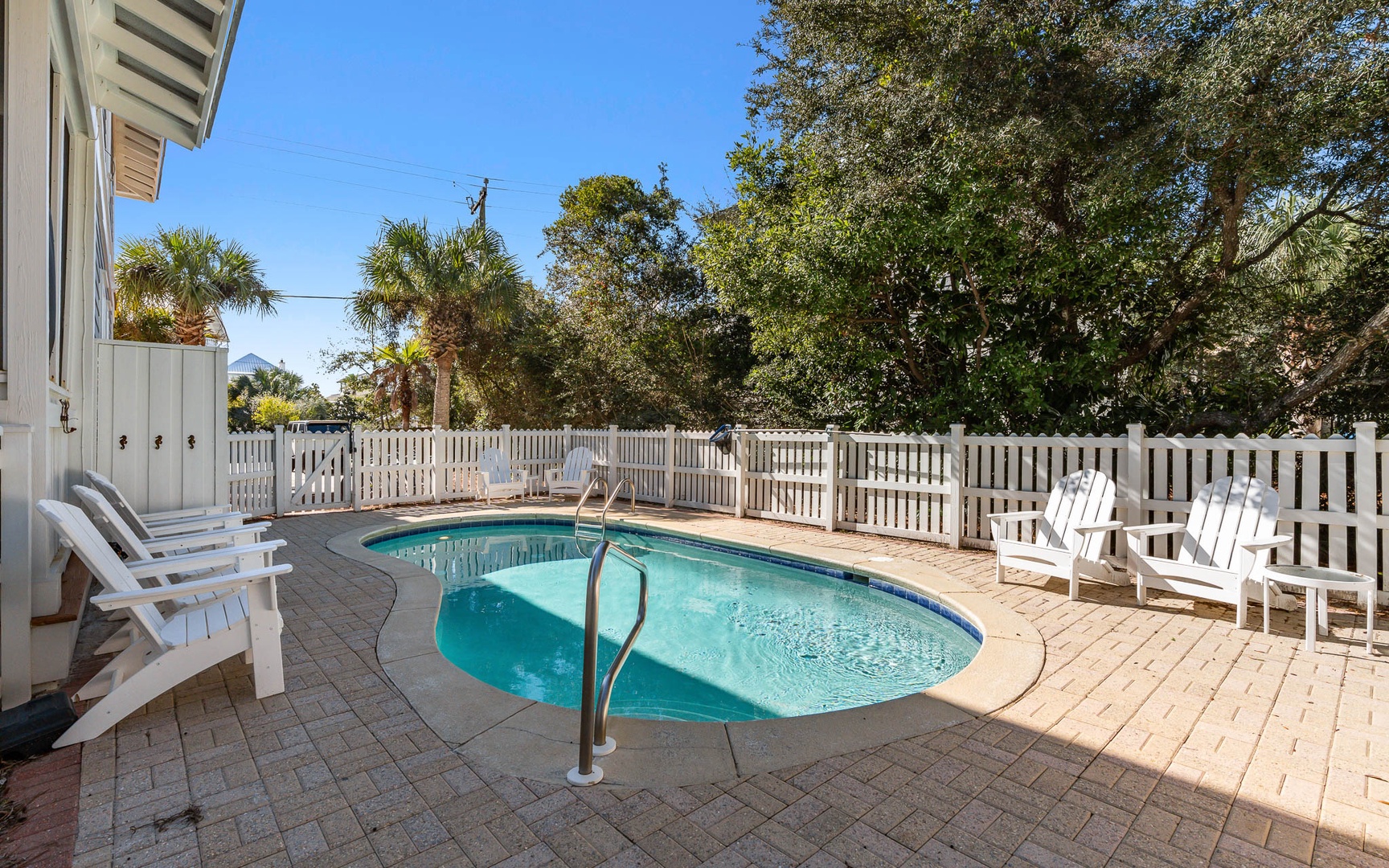 Dive into your private oasis surrounded by tropical palms and comfortable seating for perfect poolside relaxation.