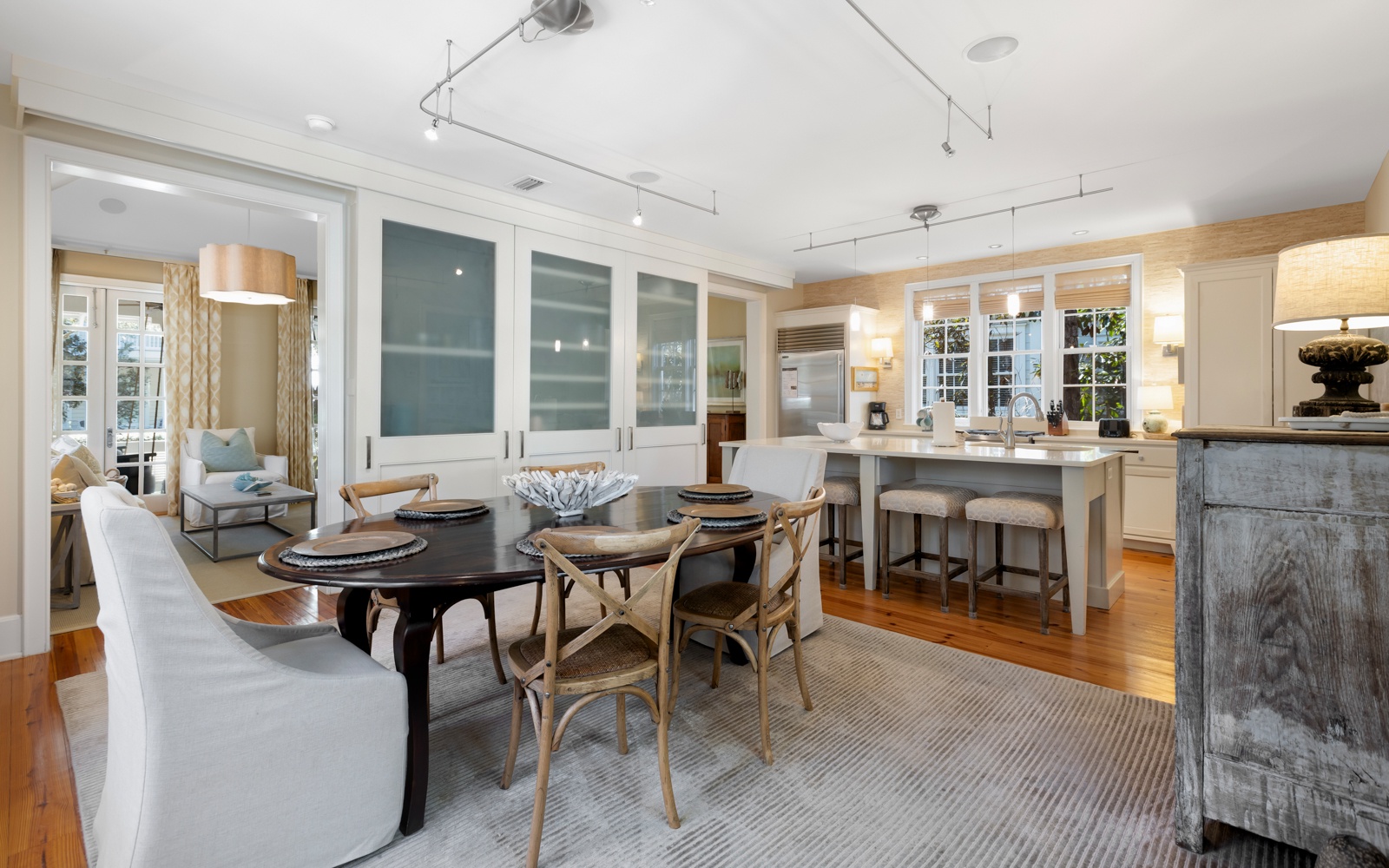 Gather around this elegant dining table where memorable meals unfold, while your culinary adventures await in the spacious, well-appointed kitchen nearby.