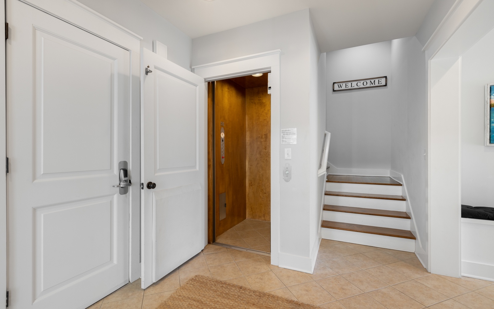Step into your welcoming entrance hall where modern convenience meets comfort—complete with elevator access for effortless arrival.