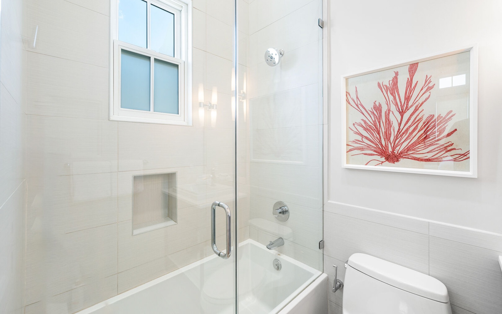 Unwind in your elegant bathroom featuring a luxurious glass-enclosed tub, perfect for soaking away the day's adventures.