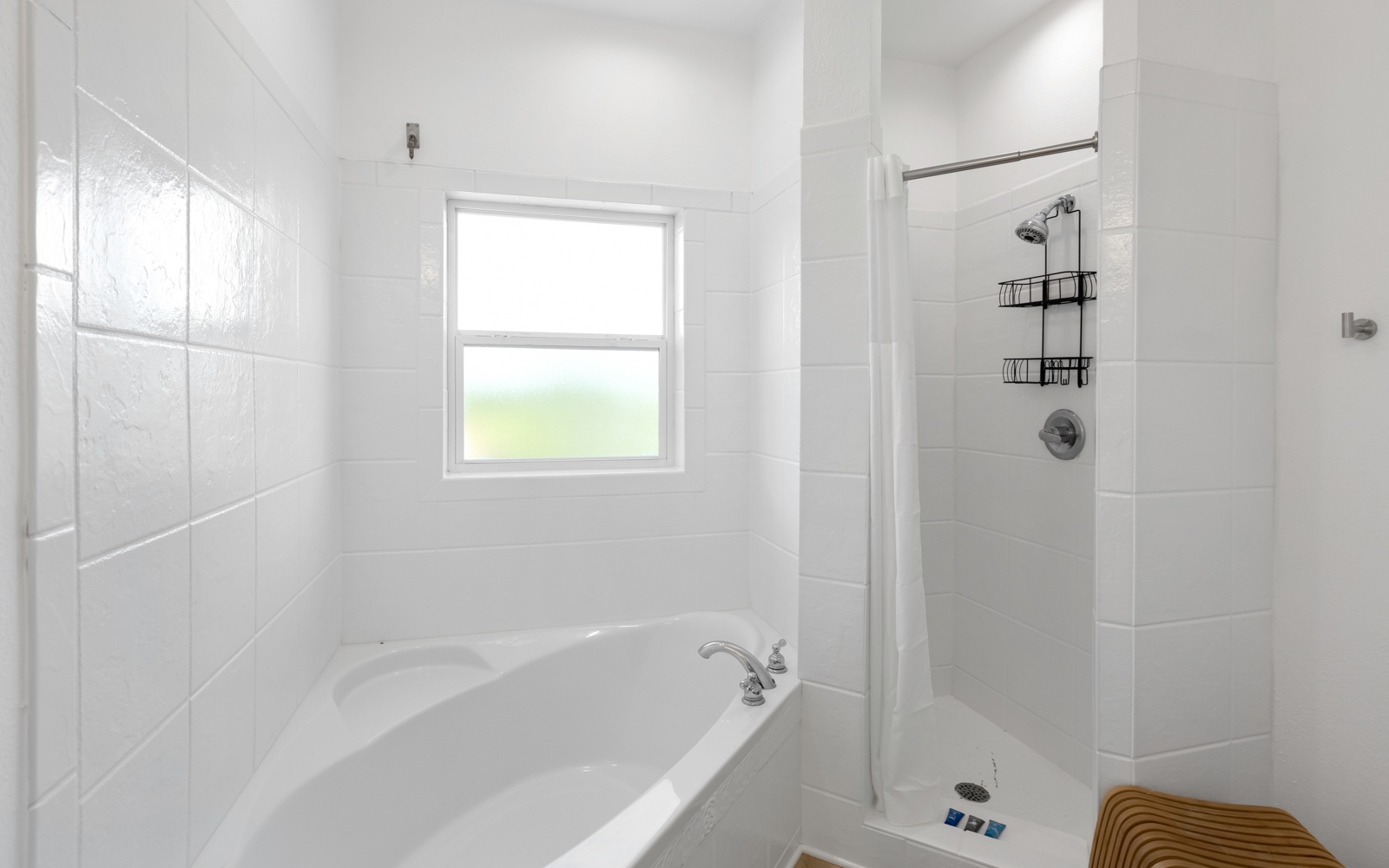 Refresh in your bright bathroom with separate soaking tub and modern shower featuring convenient organizers.