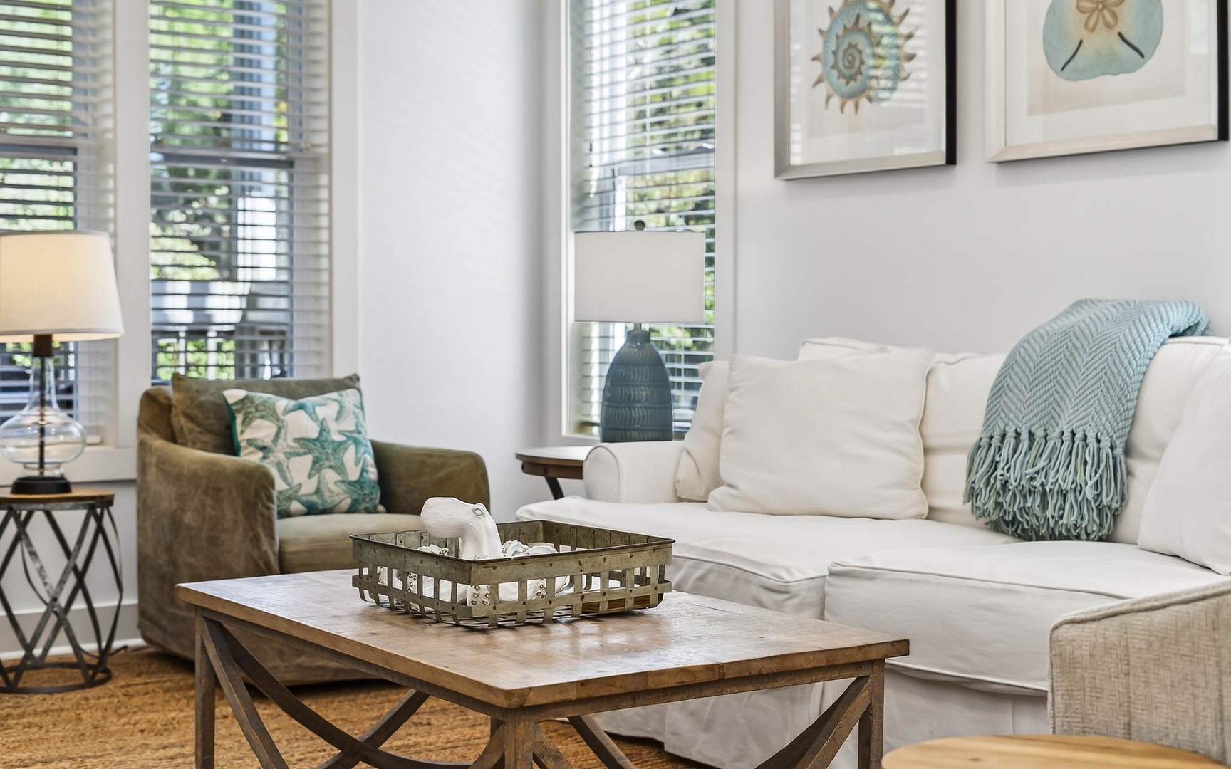 Sink into plush sofas in your bright, airy living room where coastal touches and natural light create the perfect retreat.