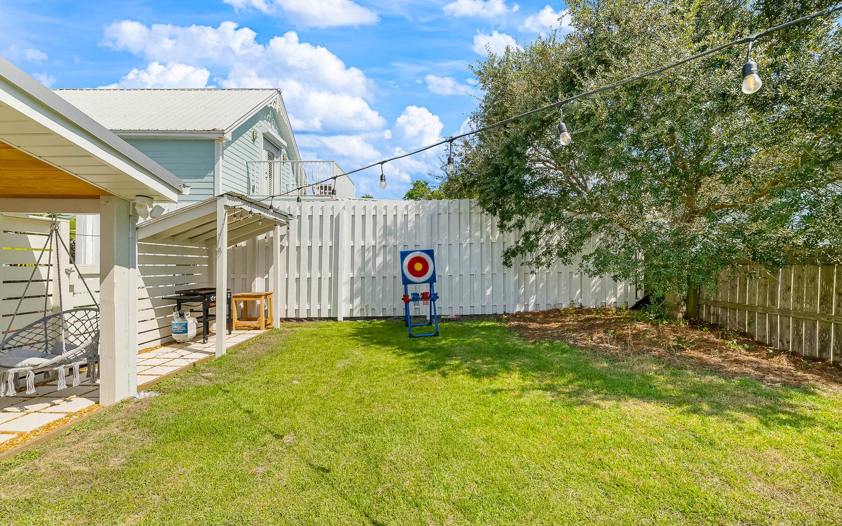 Private backyard with lawn space and target game setup - perfect for outdoor family fun and relaxation.