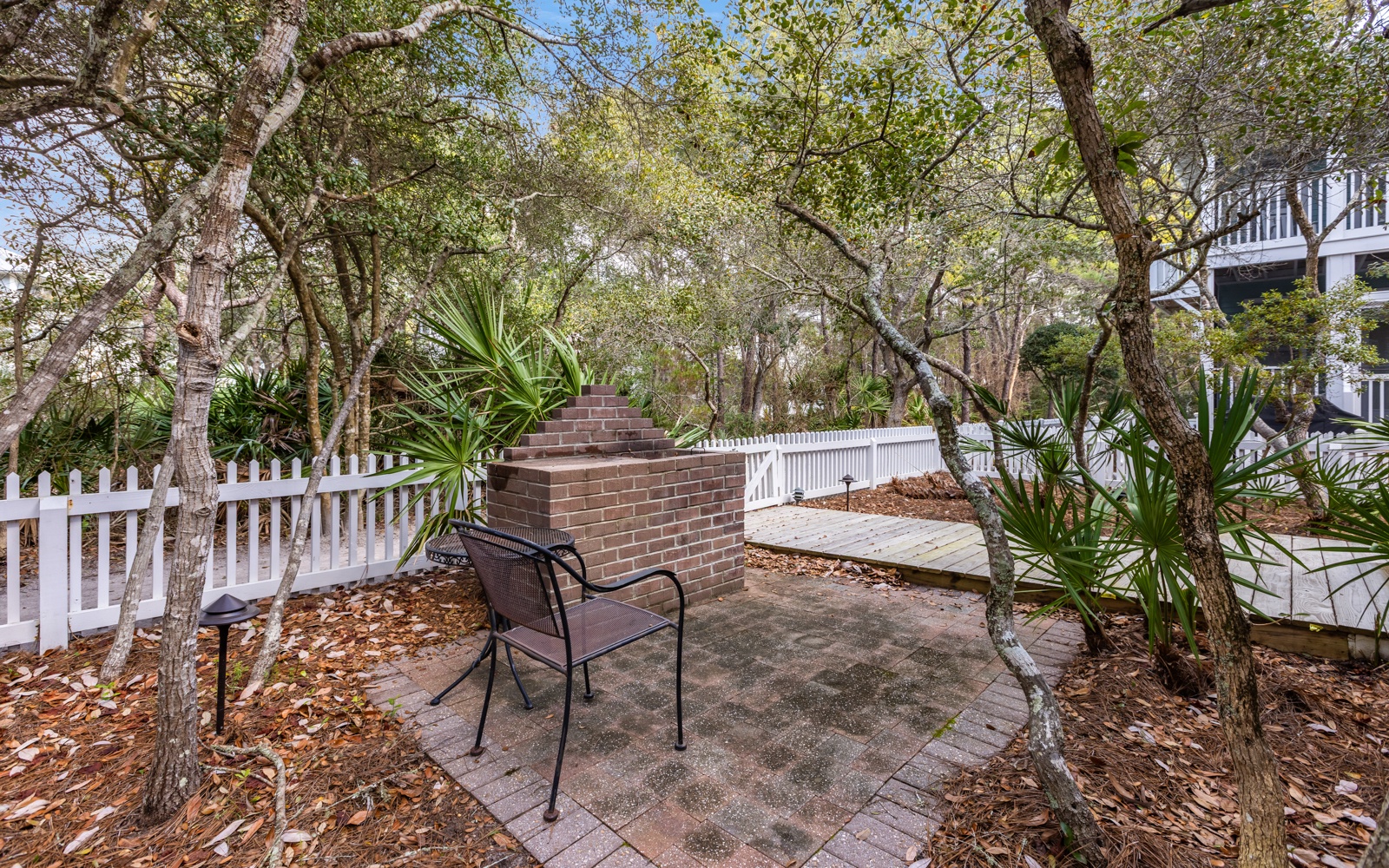 Your private patio offers peaceful seating beneath mature trees, where you can relax with morning coffee or evening drinks.