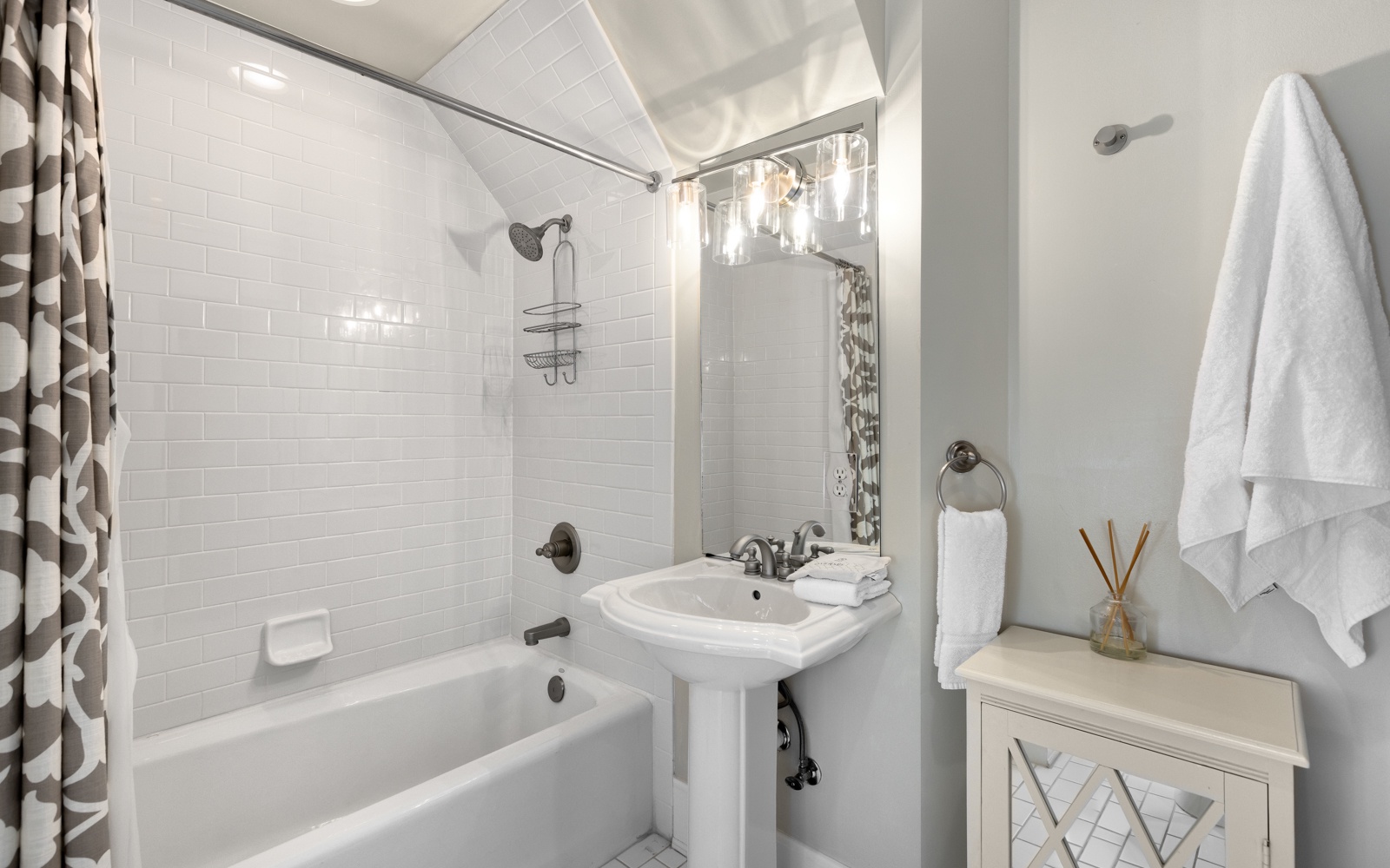 Unwind in your pristine bathroom featuring a relaxing bathtub, refreshing shower, and thoughtful touches like fluffy towels and elegant styling.