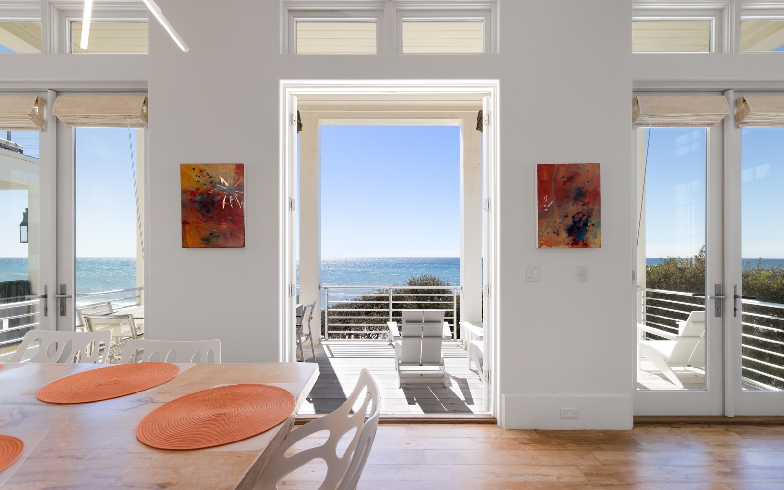 Your bright dining space opens to stunning gulf views through floor-to-ceiling doors, creating perfect indoor-outdoor flow.