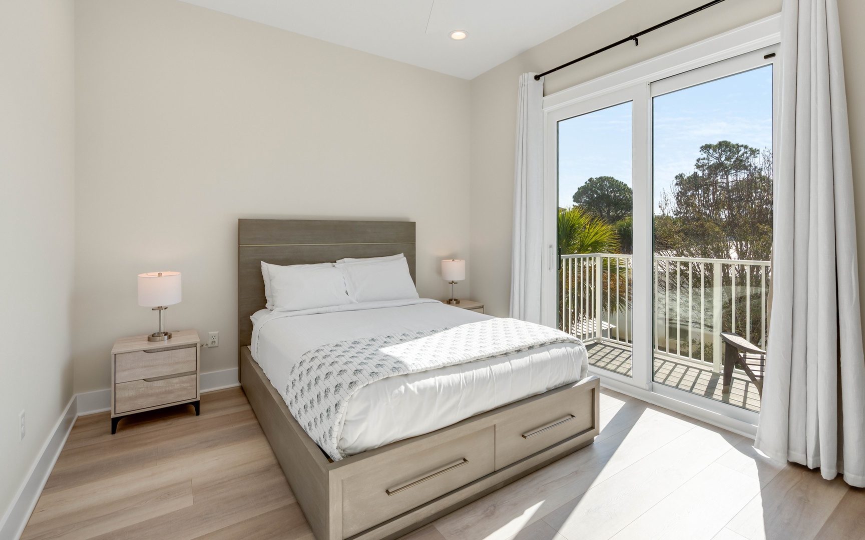 Wake up to natural light streaming through your private balcony doors in this serene bedroom retreat.