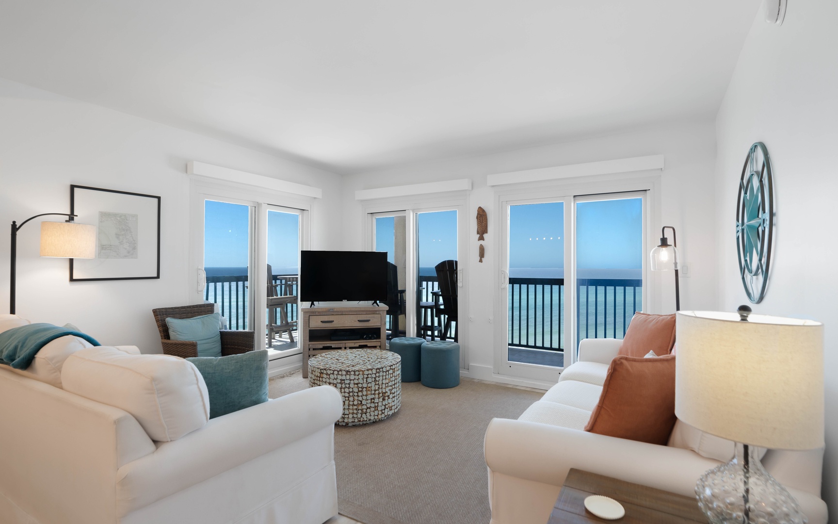 Relax in your bright oceanfront living room with stunning sea views through floor-to-ceiling windows. Sink into plush sofas and enjoy the endless horizon.