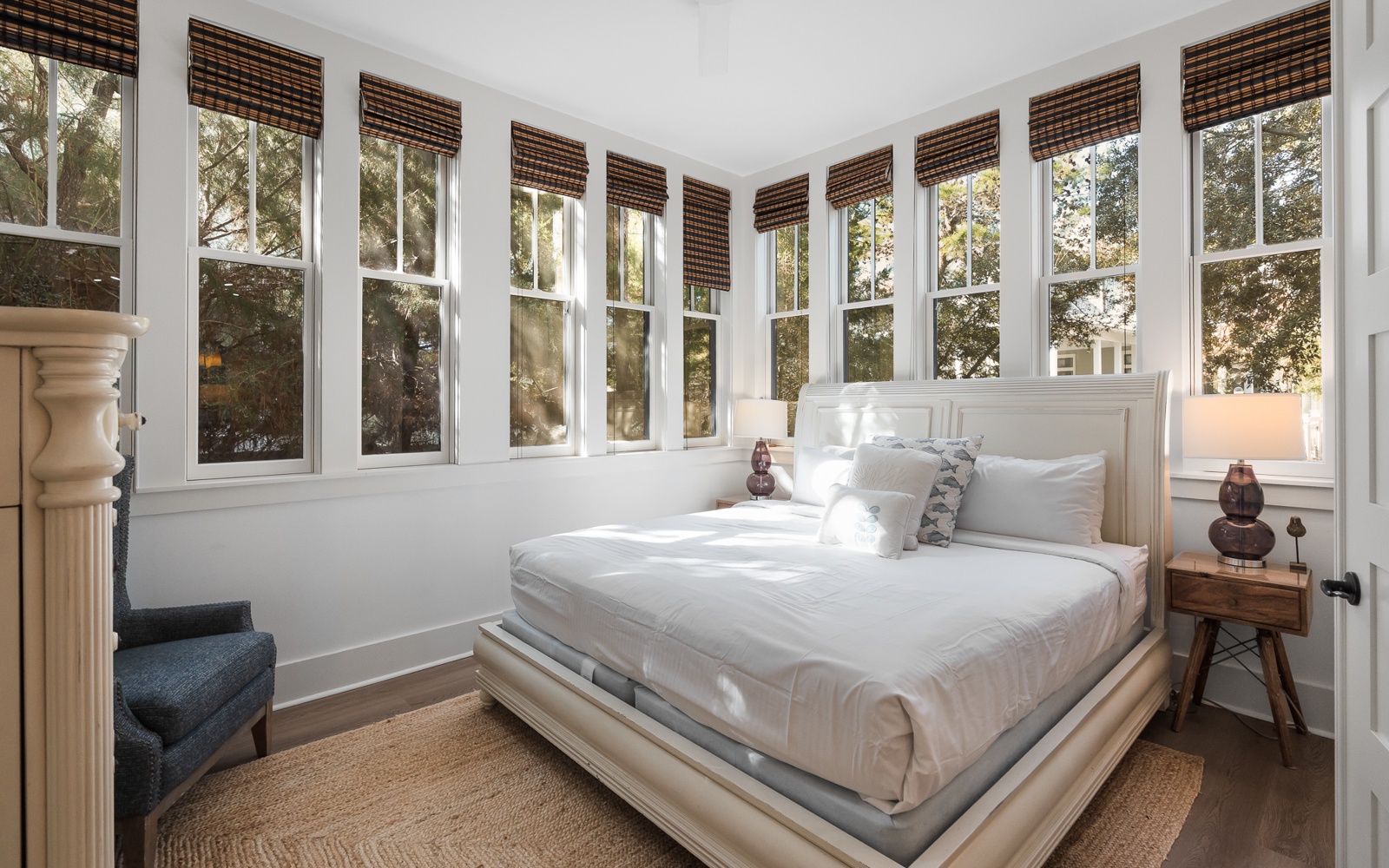 Wake up to natural light streaming through your private sanctuary, where crisp linens meet warm wood tones in perfect harmony.