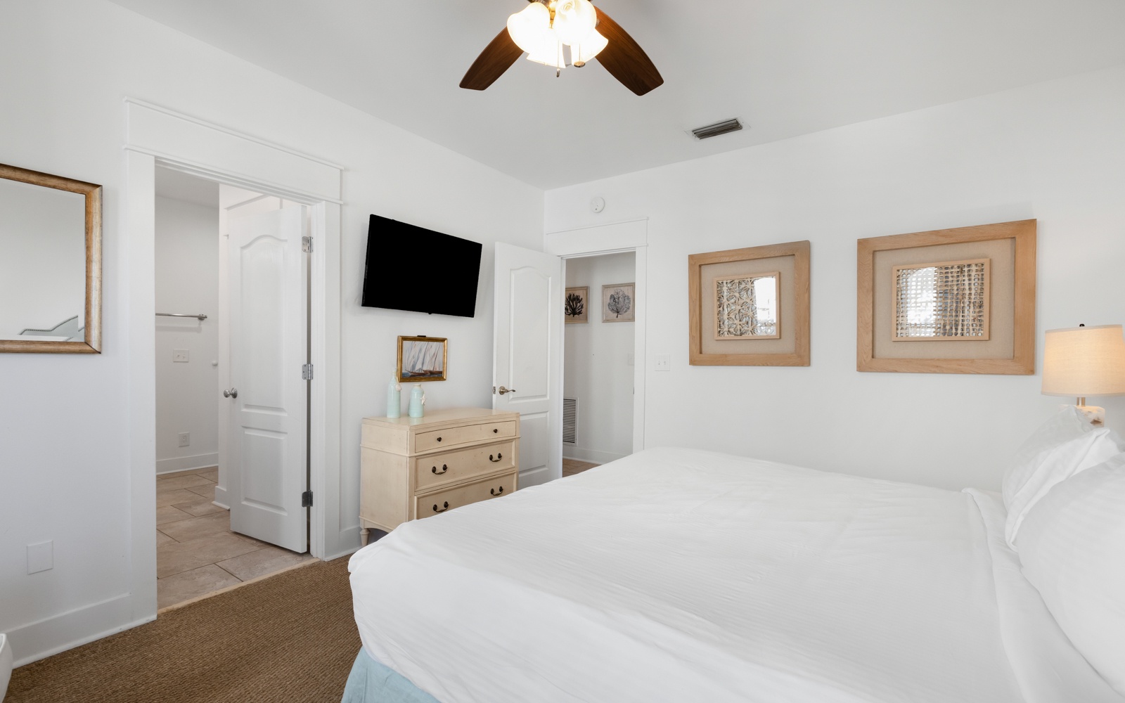 Your serene bedroom sanctuary features crisp white linens, warm coastal touches, and all the comforts you need for restful nights.