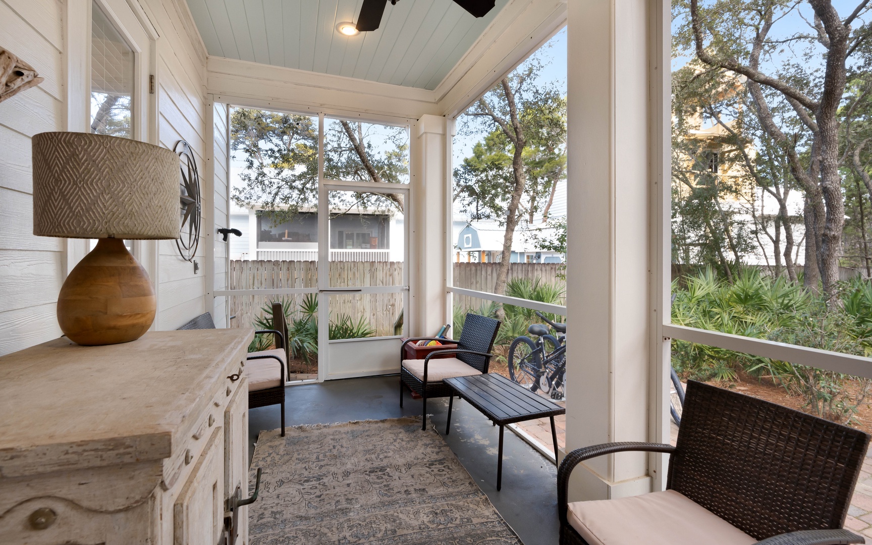Your screened porch offers a peaceful retreat with comfortable seating and garden views, perfect for morning coffee or evening relaxation.