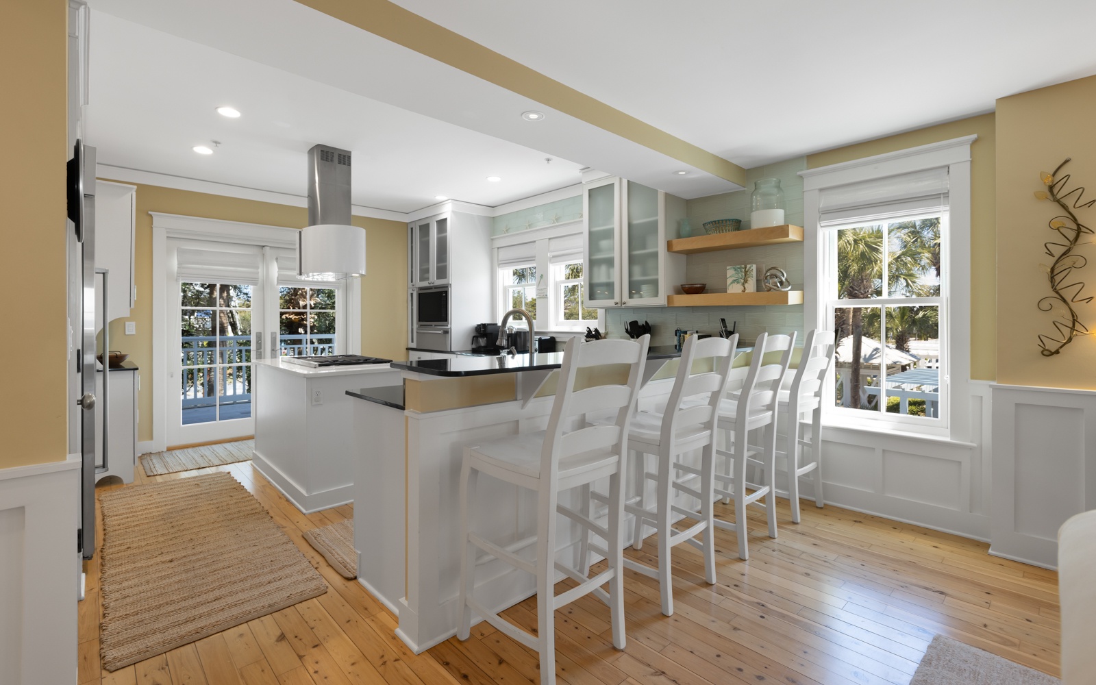 Your bright kitchen island becomes the heart of your stay, with bar seating for six and tropical views through the windows.