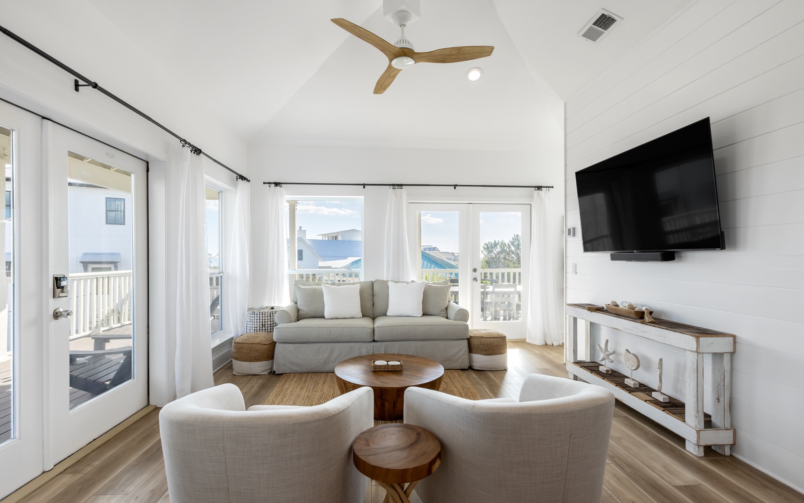 Unwind in your bright, coastal living room featuring plush seating and scenic windows that frame peaceful neighborhood views.