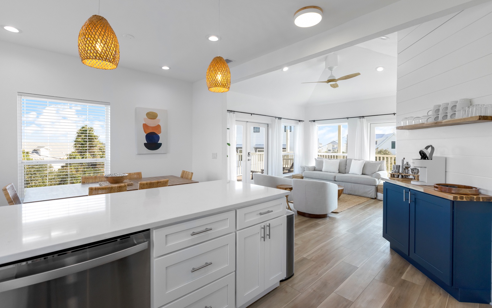 Unwind in your bright open-plan living space where natural light floods through expansive windows, highlighting modern furnishings and stylish pendant lighting.