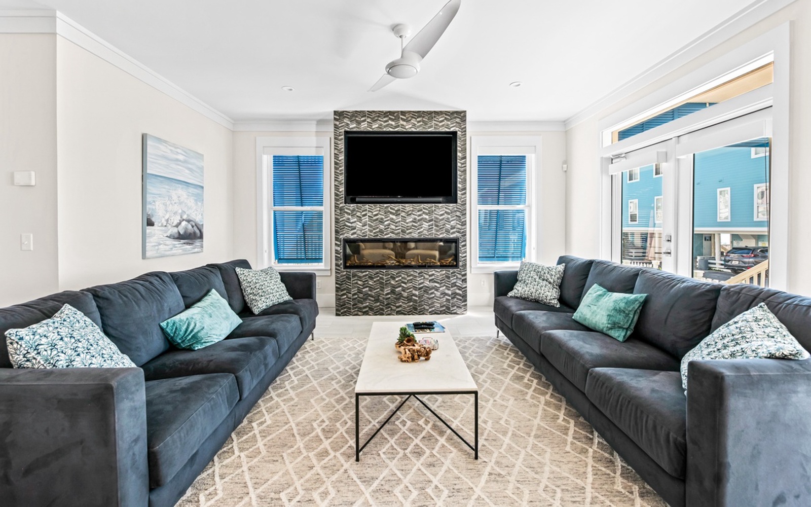 Sink into plush sectional seating while enjoying your fireplace and smart TV in this bright, contemporary living space.