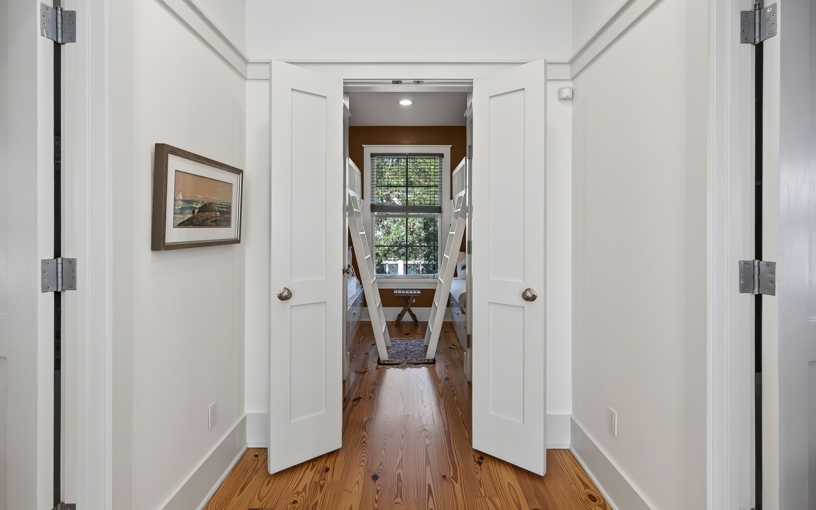 Step through these elegant double doors into your beautifully appointed space, where warm hardwood floors and tasteful decor create a welcoming atmosphere.