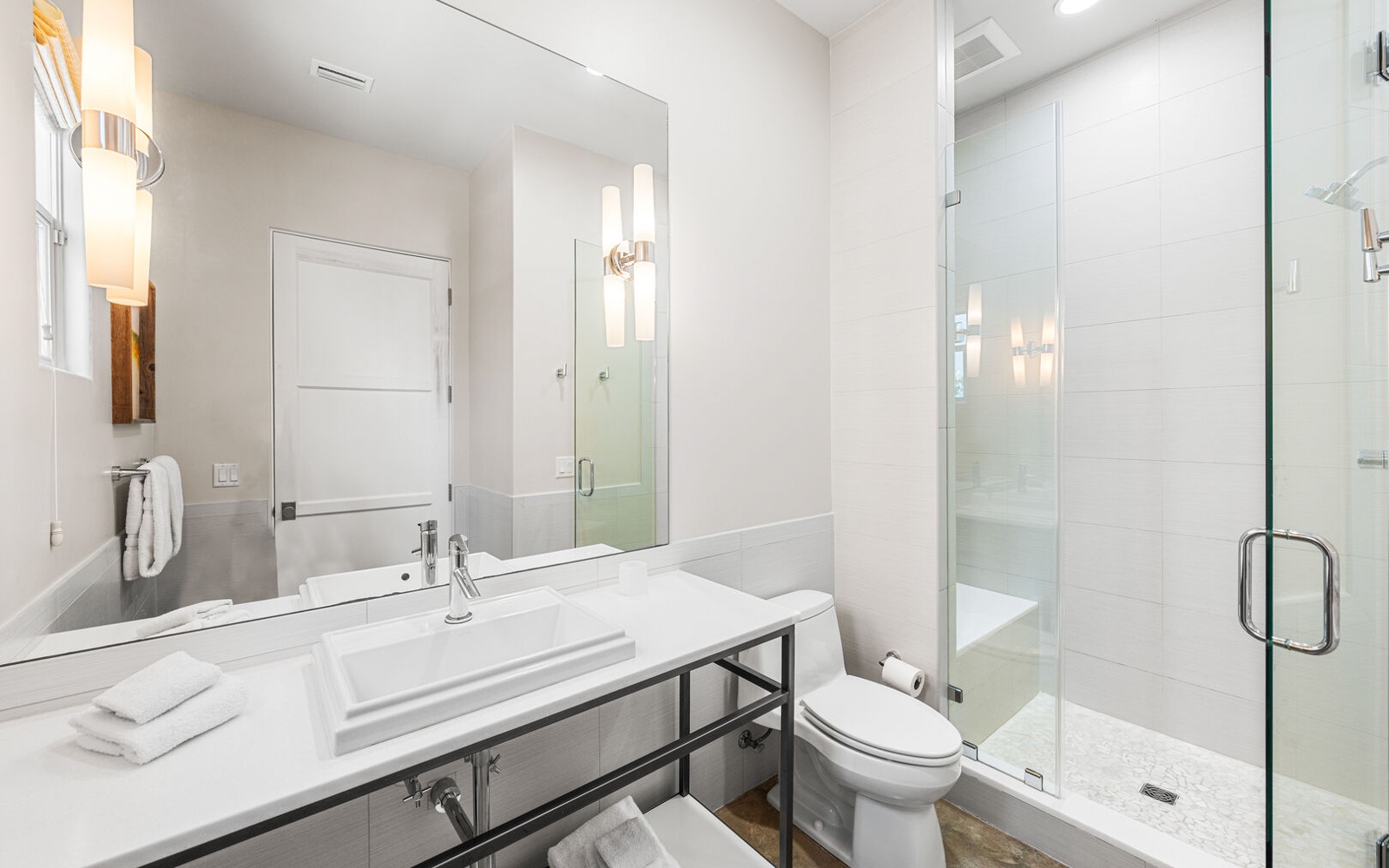 Step into your pristine bathroom where modern elegance meets comfort. Fresh towels await your arrival in this spa-like sanctuary.