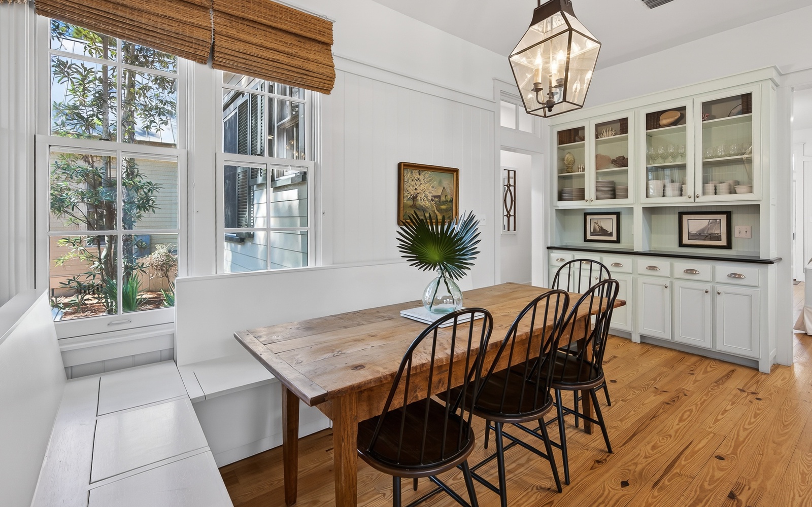 Gather around this rustic wooden dining table where your group can share memorable meals in this bright, welcoming space with built-in storage.