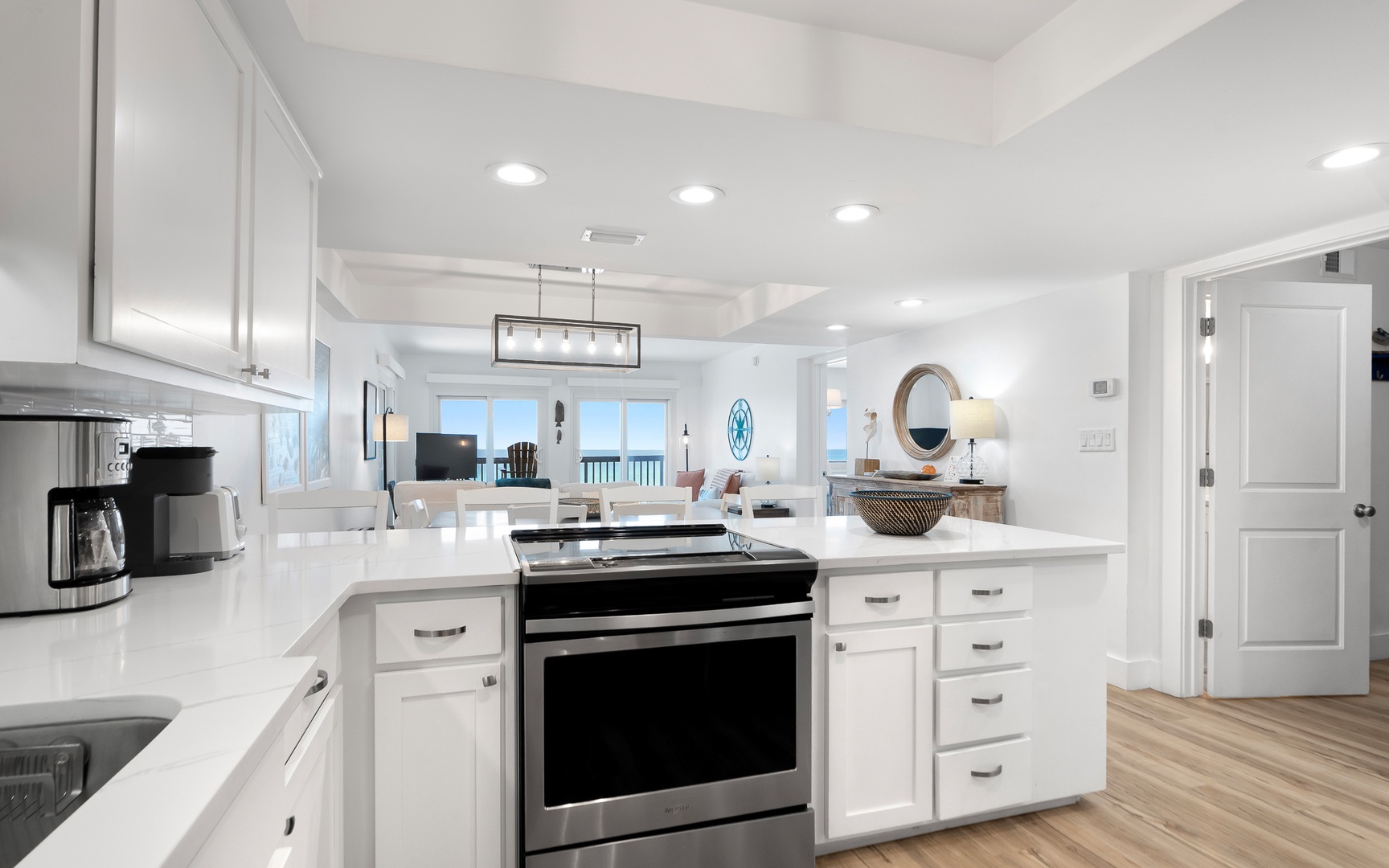 Your bright, modern kitchen invites culinary adventures with pristine white cabinets, sleek appliances, and an open flow to the living area.