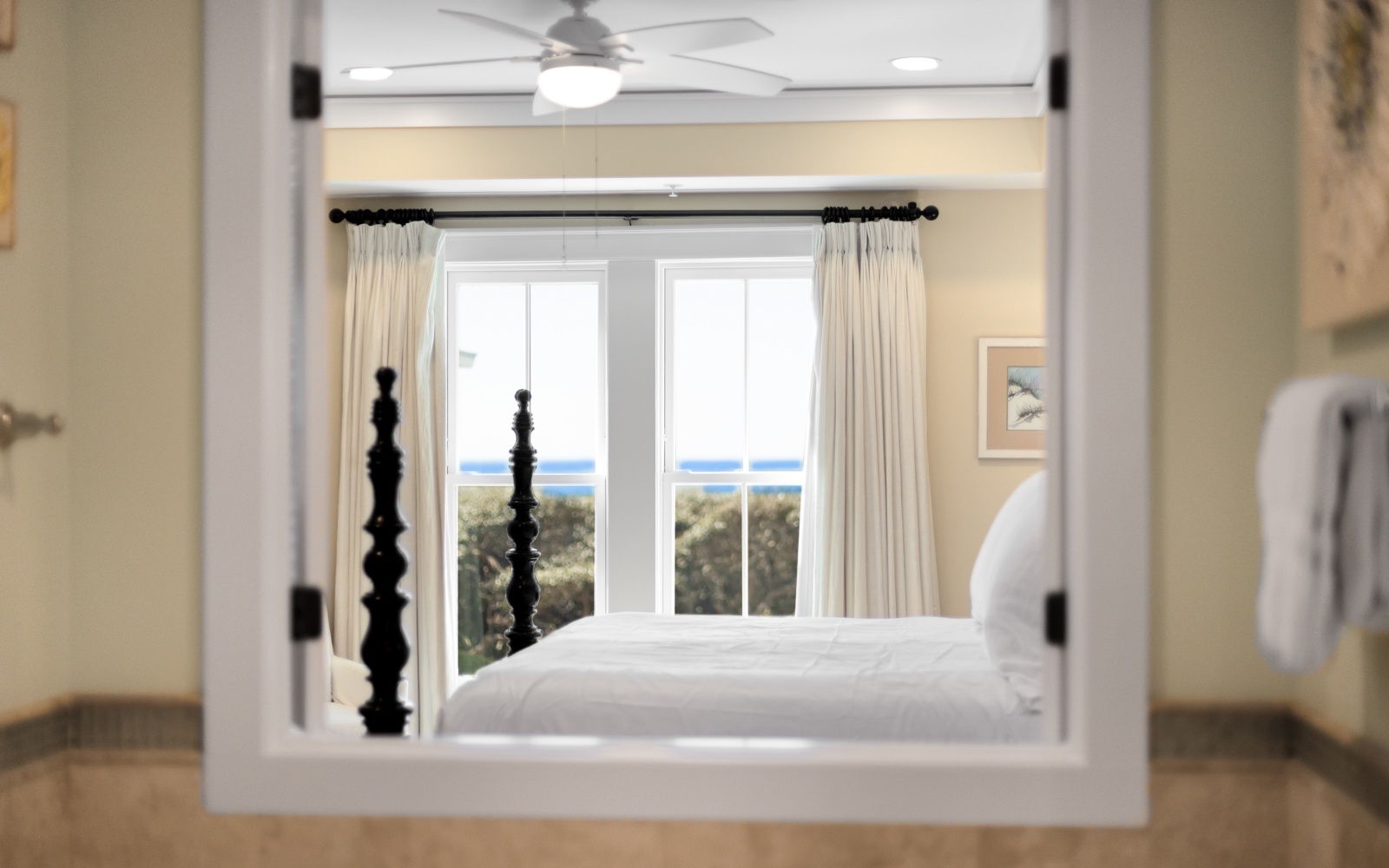 Wake up to stunning ocean views from your cozy bedroom, where crisp linens and gentle sea breezes create the perfect coastal retreat.