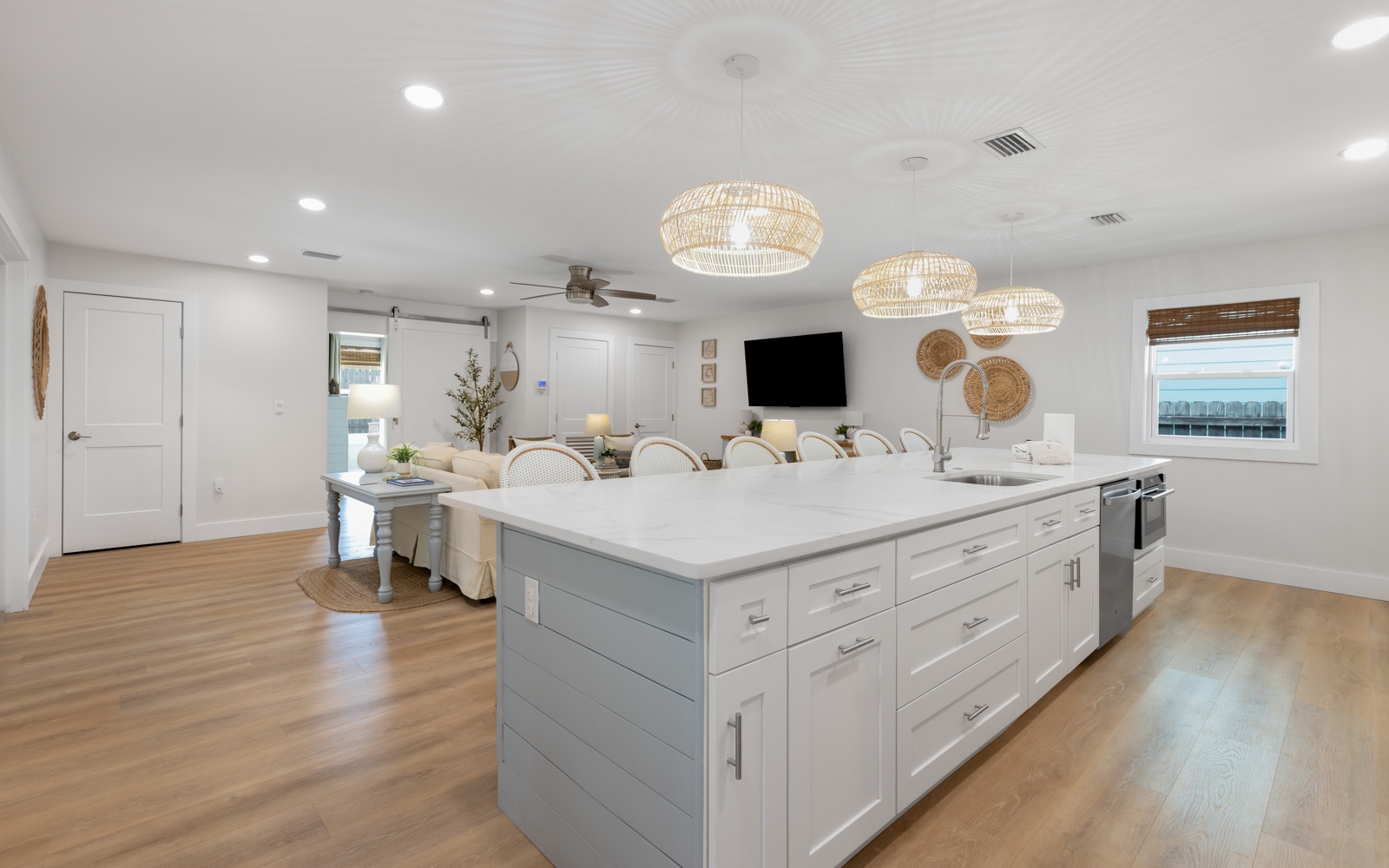 Gather around your spacious kitchen island where coastal charm meets modern comfort - perfect for morning coffee and evening conversations.