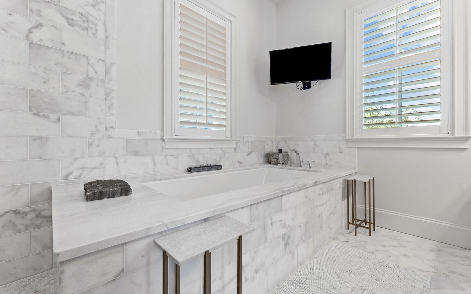 Soak in luxury within your marble sanctuary, complete with TV for ultimate relaxation.