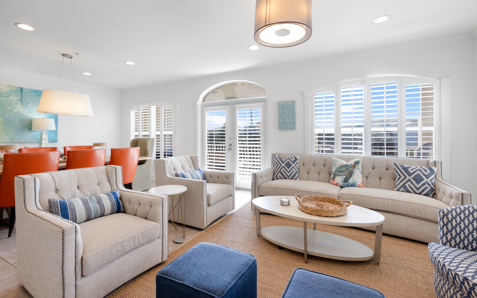 Sink into plush seating and enjoy natural light streaming through plantation shutters in your elegant living space.