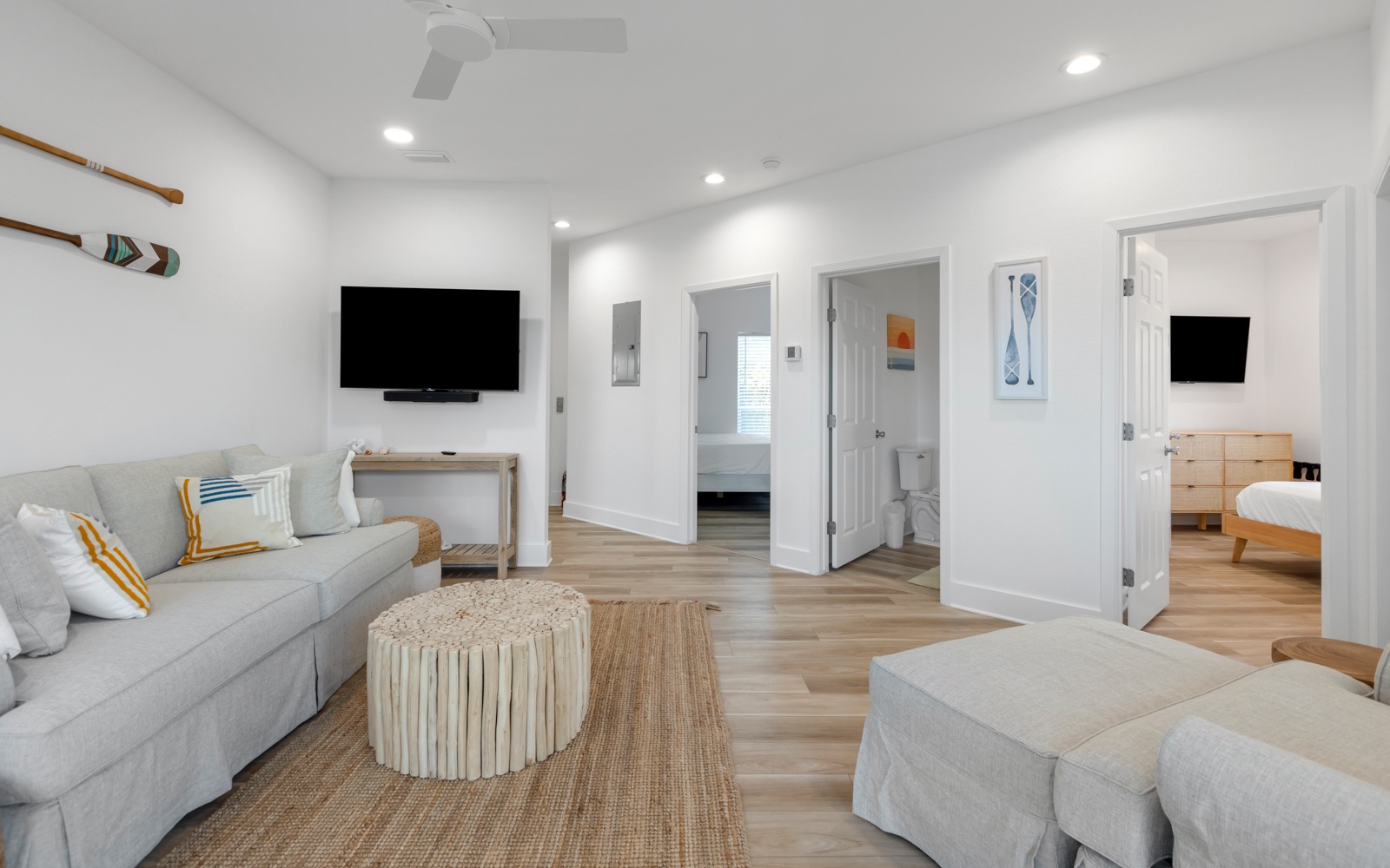 Relax in your bright living room with plush seating, flat-screen TV, and coastal touches creating the perfect vacation retreat.