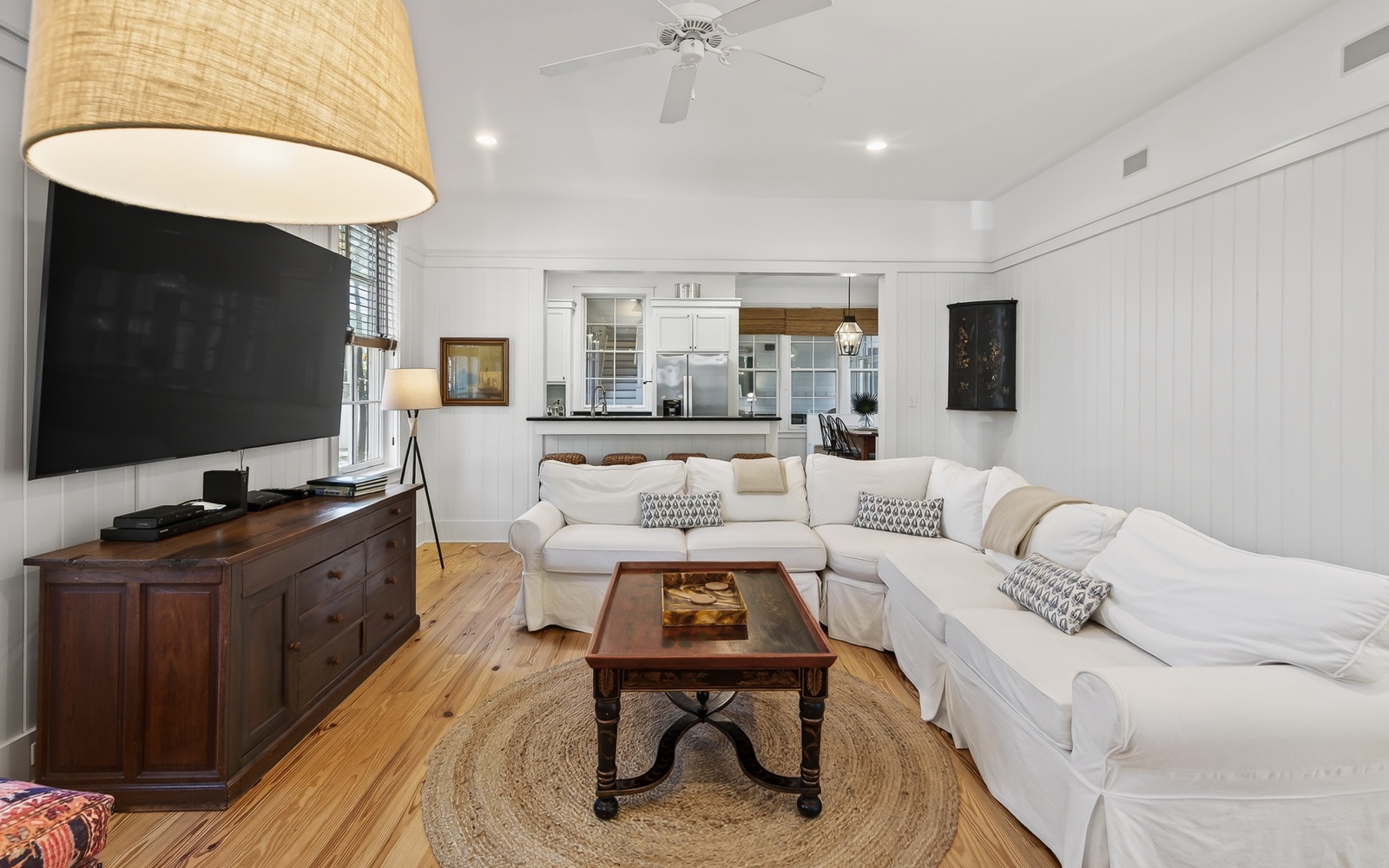 Unwind in your bright, airy living space with plush white sofas and coastal charm for ultimate relaxation.