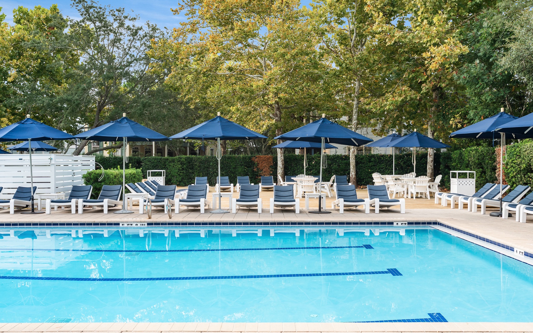 Dive into crystal-clear waters and unwind on comfortable loungers under shady umbrellas, surrounded by lush autumn foliage.