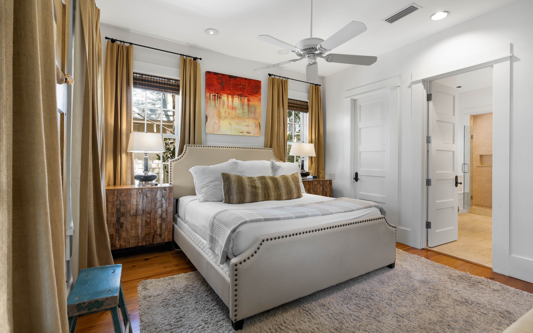 Sink into your comfortable bed surrounded by warm colors, soft lighting, and thoughtful touches that make this space feel like home.