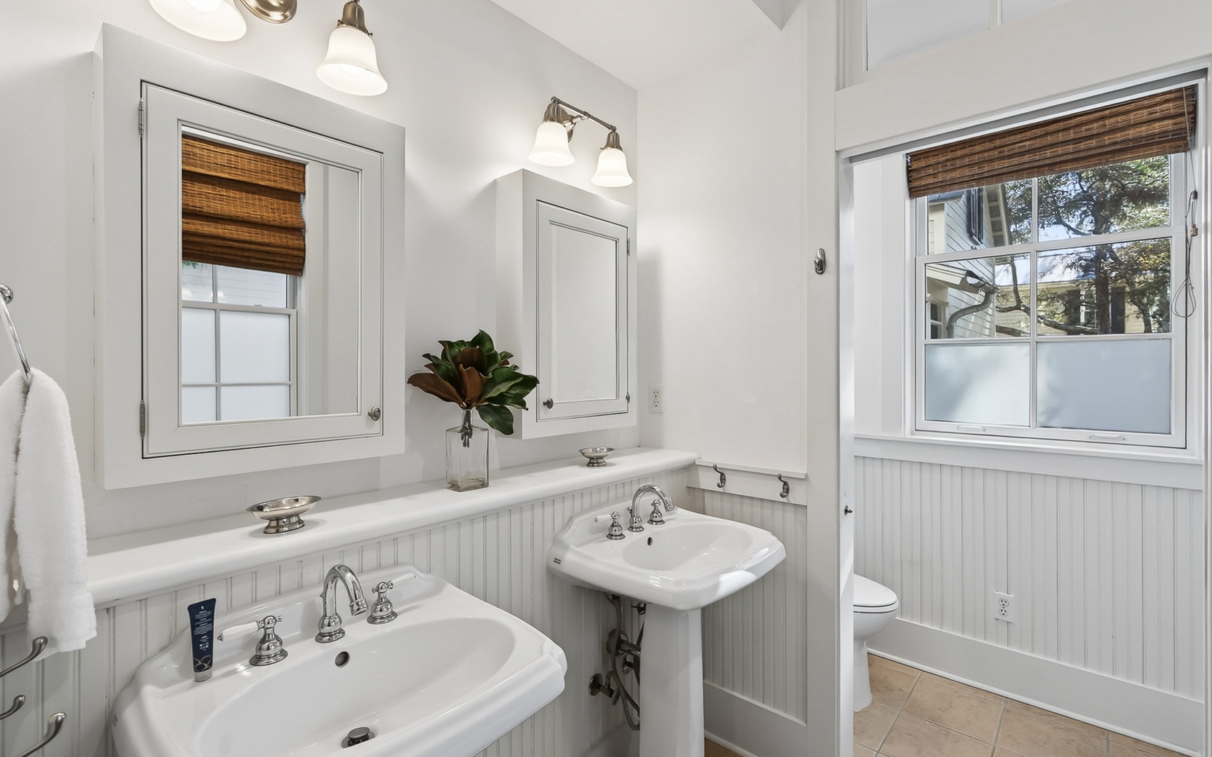 Step into your beautifully appointed bathroom with dual pedestal sinks, perfect for your morning routine together.