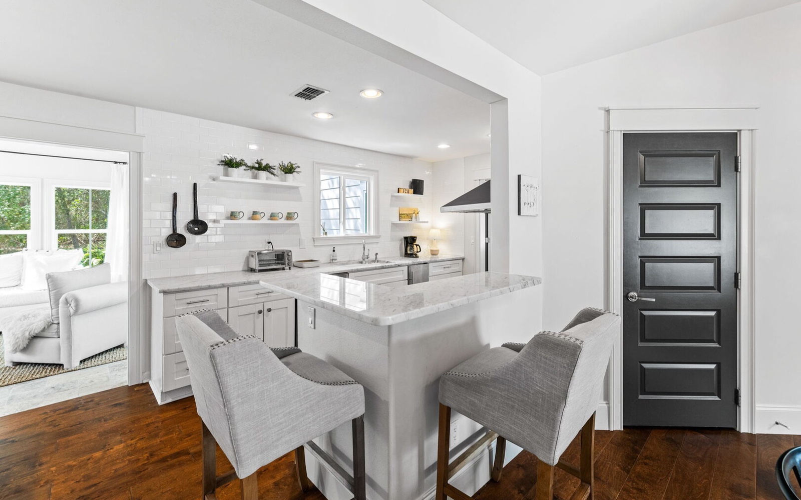 Your sleek kitchen invites culinary adventures with marble countertops, modern appliances, and comfortable bar seating for morning coffee or evening wine.
