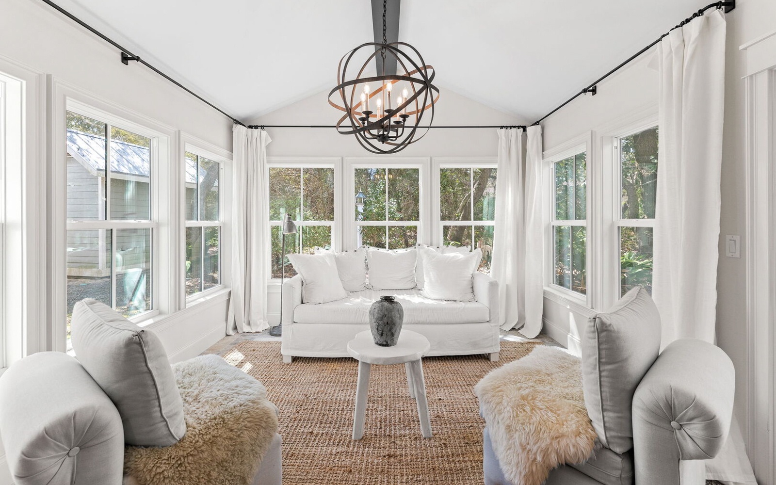 Step into your bright sunroom sanctuary, where plush seating and panoramic windows create the perfect spot for morning coffee or evening relaxation.