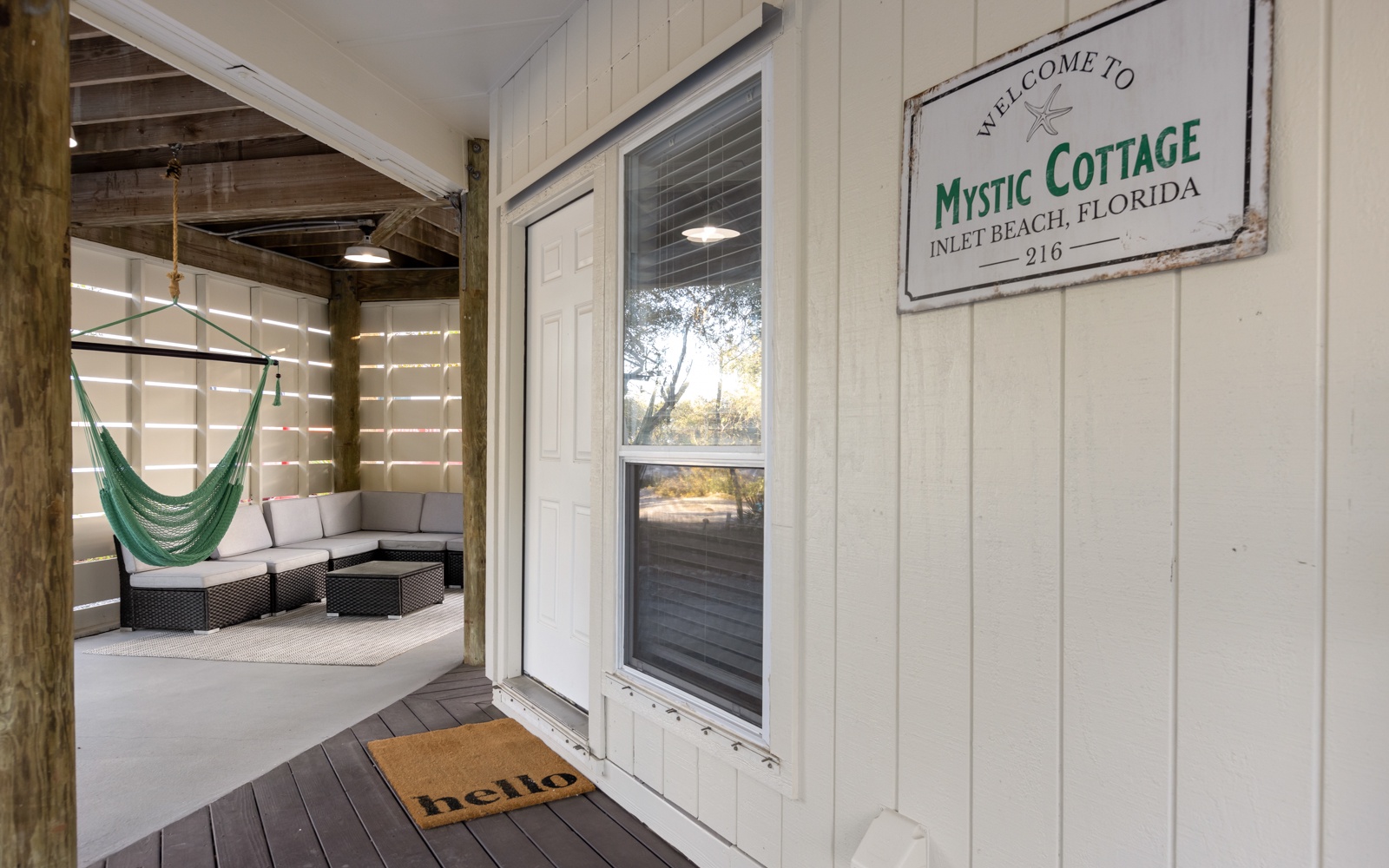 Welcome to Mystic Cottage! Step onto your private porch with inviting seating and a dreamy hammock for ultimate relaxation.