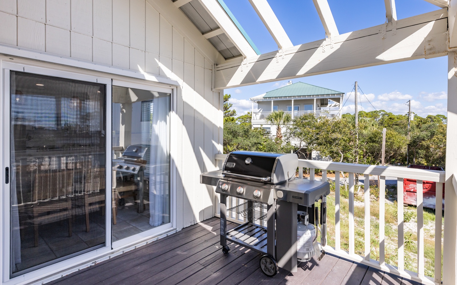 Step onto your private deck with a premium gas grill ready for outdoor cooking adventures under the pergola's shade.