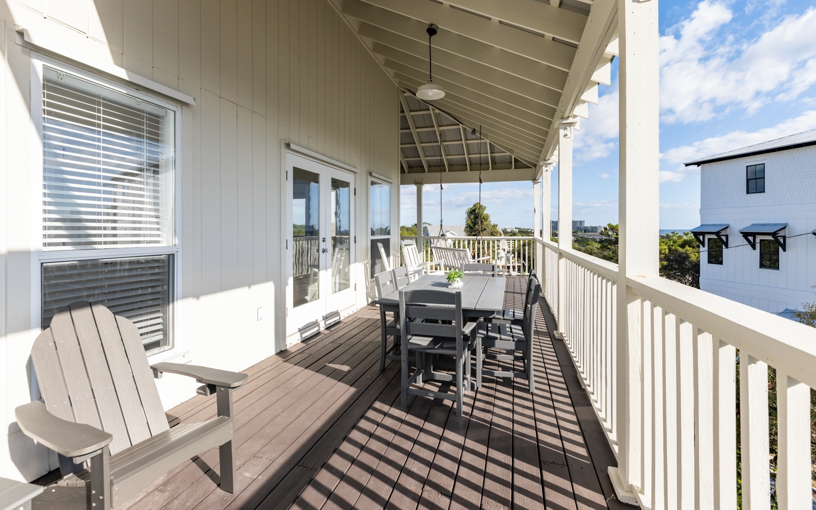 Your private deck awaits with comfortable seating and ocean glimpses, perfect for morning coffee or sunset dinners.