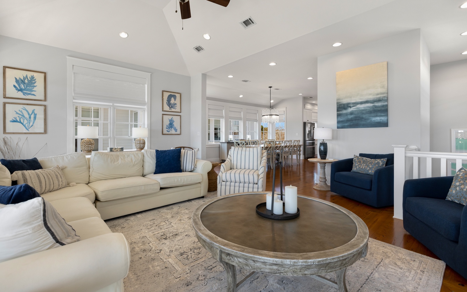 Sink into the plush sectional sofa where coastal blues meet creamy whites, creating your perfect retreat for morning coffee or evening conversations.