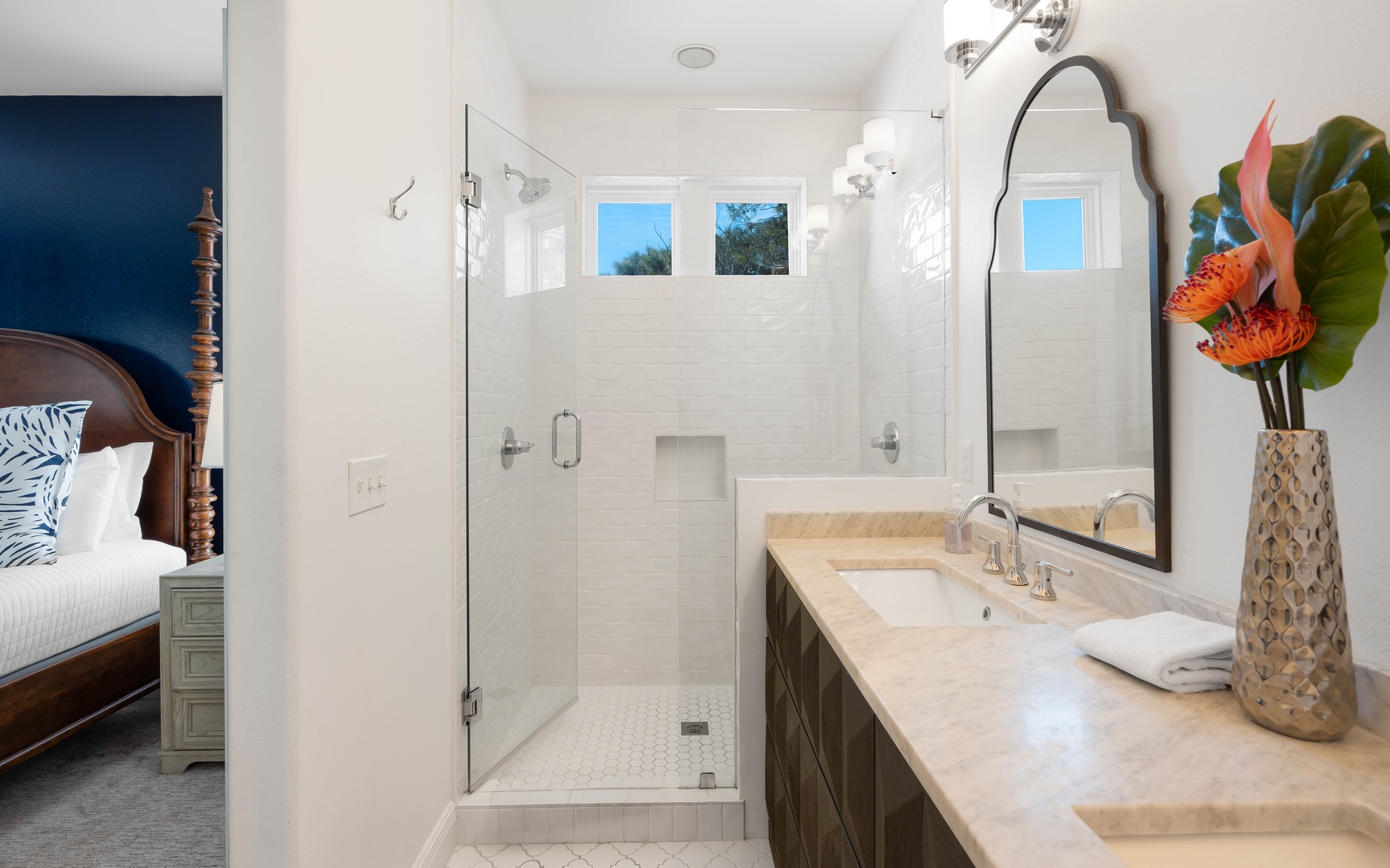 Your private ensuite bathroom features elegant marble counters, a spacious walk-in shower, and tropical touches for a spa-like experience.